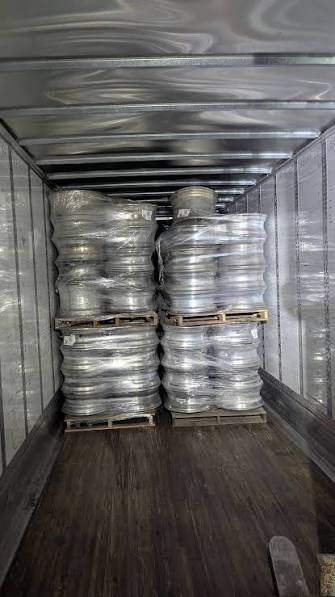 Palletized aluminum wheel scrap loaded inside a shipping container